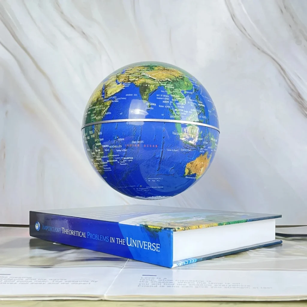 A globe levitates above an open book