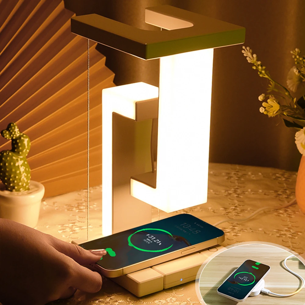 Modern table lamp with built-in wireless phone charger on a decorative surface, featuring a cactus plant and flowers.