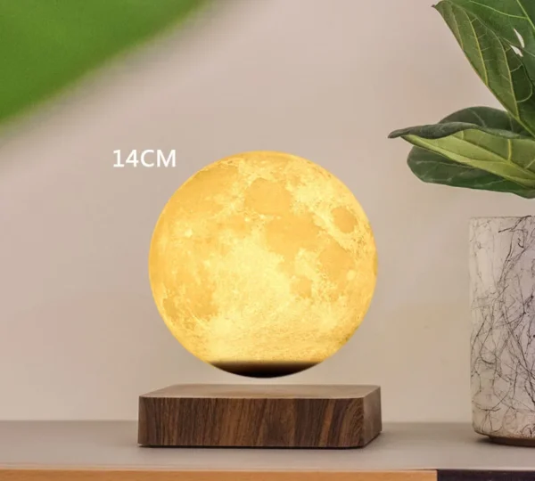 A moon-shaped lamp measuring 14 centimeters in diameter, floating above a wooden base, next to a green plant in a white pot. A moon-shaped lamp measuring 14 centimeters in diameter, floating above a wooden base, next to a green plant in a white pot.